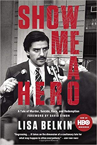 A dark-haired man with a mustache wearing a suit stands with multiple reporters sticking microphones in his face. Over the black and white photo are large red block letters saying "Show Me a Hero." Smaller type gives author Lisa Belkin and notes the book is now an HBO show.