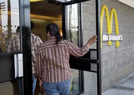 A view from the back of a person walking through the door of a McDonald's in Los Angeles, for an article on the health agenda of the next president