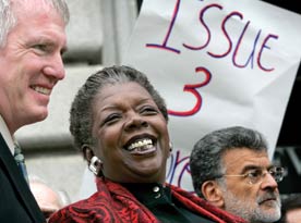 Photo of a smiling Stephanie Tubbs Jones at an outdoor event, standing between two other people.