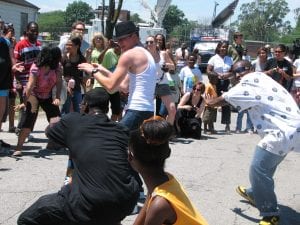 White and Black youths dance together in the street in Gary Indiana