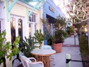 neighborhood revitalization: cafe tables and potted palms line the sidewalk in the Northwood section of West Palm Beach.