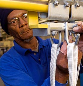 A worker at Evergreen Cooperative Laundry, which recently secured new contracts for 3 million pounds of health care linens.