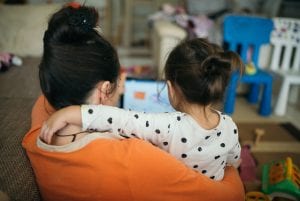 Back view of a mother and daughter looking at a laptop, illustrating an article about HAMP, or the Home Affordable Modification Program