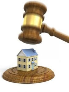 foreclosure and hospitalization. Illustration shows gavel coming down upon a small house