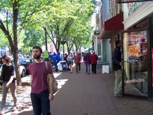 view of sidewalk with people walking, window-shopping