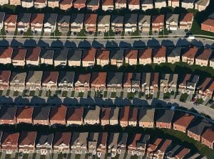 aerial view of suburban development; rural places once built upon are reverting to nature