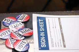 voting rights. Image shows pins saying "VOTE" 