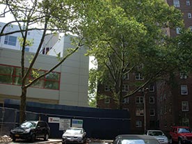 Exterior photograph of a building that houses Promise Academy, for an article on NYCHA and open space