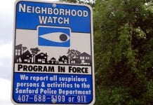 a street sign saying a neighborhood watch program is in force