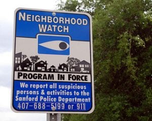 a street sign saying a neighborhood watch program is in force