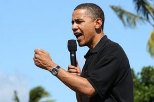 President Barack Obama speaks while holding a microphone. He was a former community organizer.