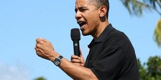 President Barack Obama speaks while holding a microphone. He was a former community organizer.