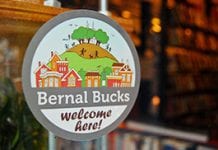 A sticker on a window promotes Bernal Bucks, a business initiative in San Francisco.
