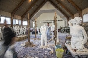 Artist works on stone body casting in the former Church of Love site, owned by the Cook Inlet Housing Authority in Alaska.