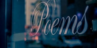 A window sign that reads "poems."