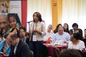 A woman who attended the 2016 National Housing Conference's event in New York City speak at the microphone.