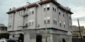 A grey-colored apartment building in Oakland California.