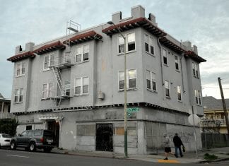 A grey-colored apartment building in Oakland California.