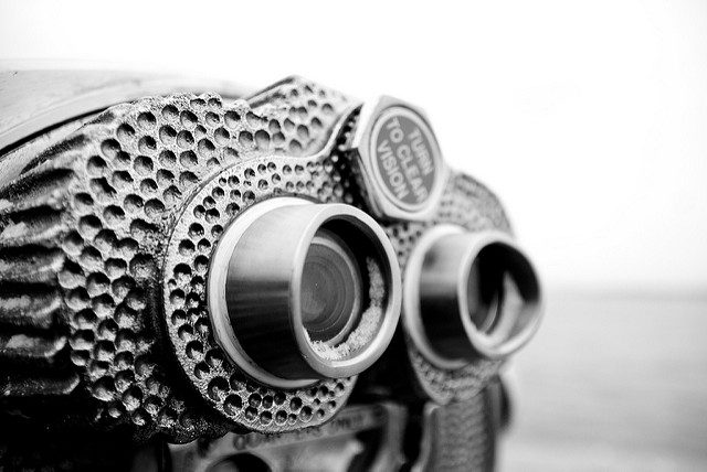 Close-up black and white photo of binoculars.