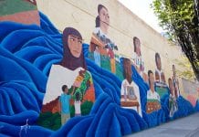 Mural on wall with faces of girls looking into the distance.