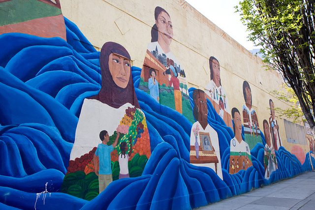 Mural on wall with faces of girls looking into the distance.