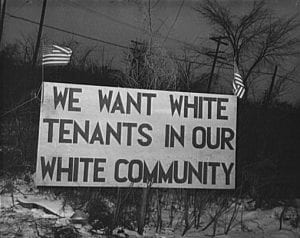 A black and white photograph from 1942 of a sign that read "We want white tenants in our white community."
