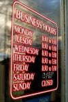Business Hours sign on glass door.