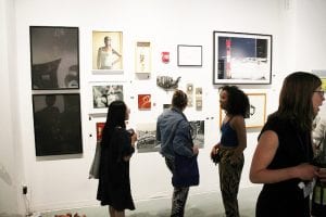 Patrons looking at gallery wall.