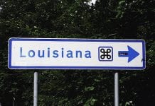 A blue and white Louisiana road sign.