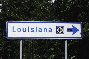 A blue and white Louisiana road sign.