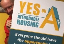 Chris Wilder, Valley Medical Center Foundation CEO, holds a sign that reads "Yes on A: Affordable Housing. Everyone should have the opportunity to live in a safe, healthy, affordable home." The initiative tied health and housing funding for county residents.