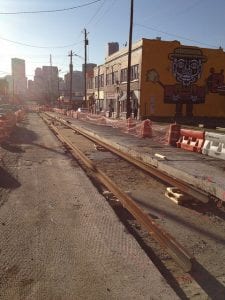 Afternoon light shines on street under construction for BeltLine streetcar.