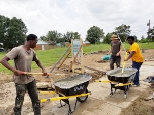 3 men mixing concrete