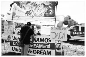 Black-and-white photo of DACA information table.