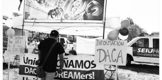 Black-and-white photo of DACA information table.