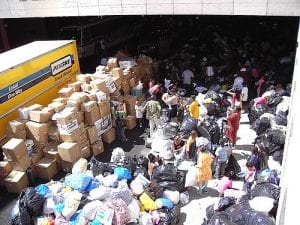 People line up next to donation items after Hurricane Katrina.