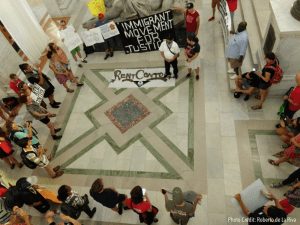 Aerial shot of people gathered in city hall lobby.