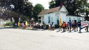 Marchers walk down a street.