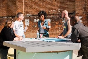 People gathered outdoors around a table.