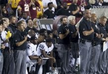 Football players kneel during national anthem.