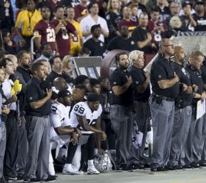 Football players kneel during national anthem.