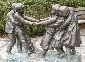 Statue of children playing tug of war.