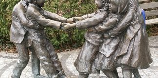 Statue of children playing tug of war.