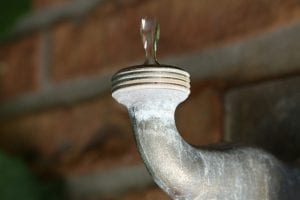 Upside-down image of a faucet dripping.