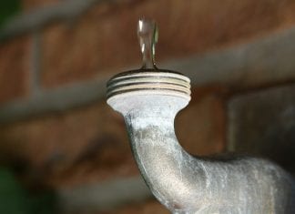Upside-down image of a faucet dripping.