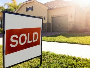 home with sold sign in front