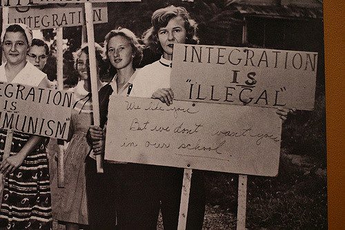 1950's young women holding anti-integration signs