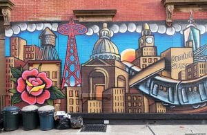 NYC skyline painted on brick wall.