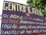 sign defining "gentrification"