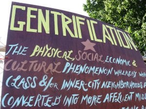 sign defining "gentrification"